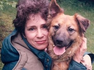 Samantha Mullen posing with German Shepherd.